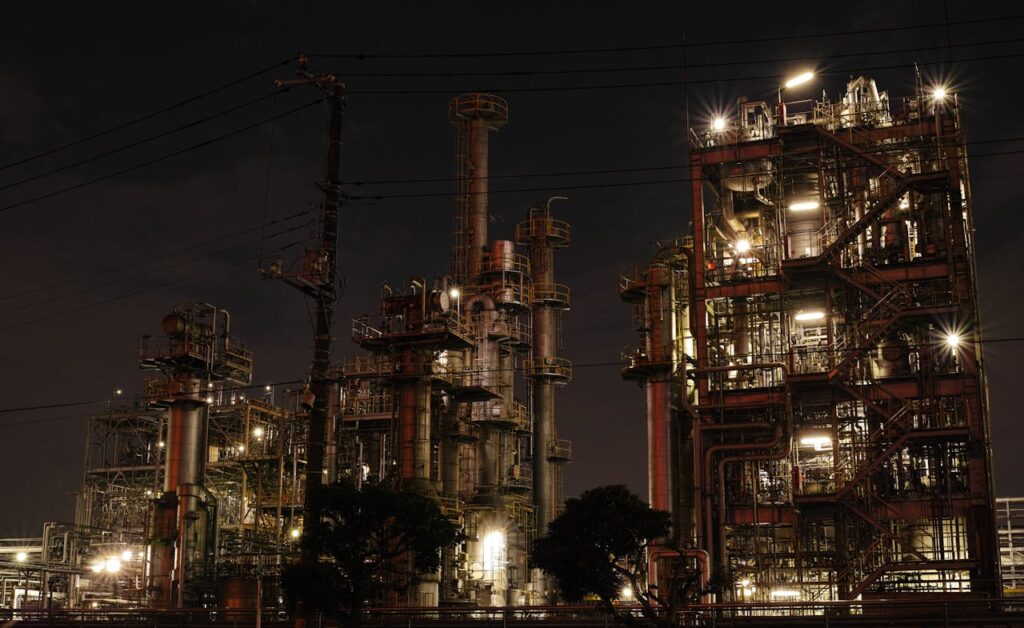 pexels photo 236722 Night view of a brightly lit industrial facility showcasing intricate steel structures and machinery.